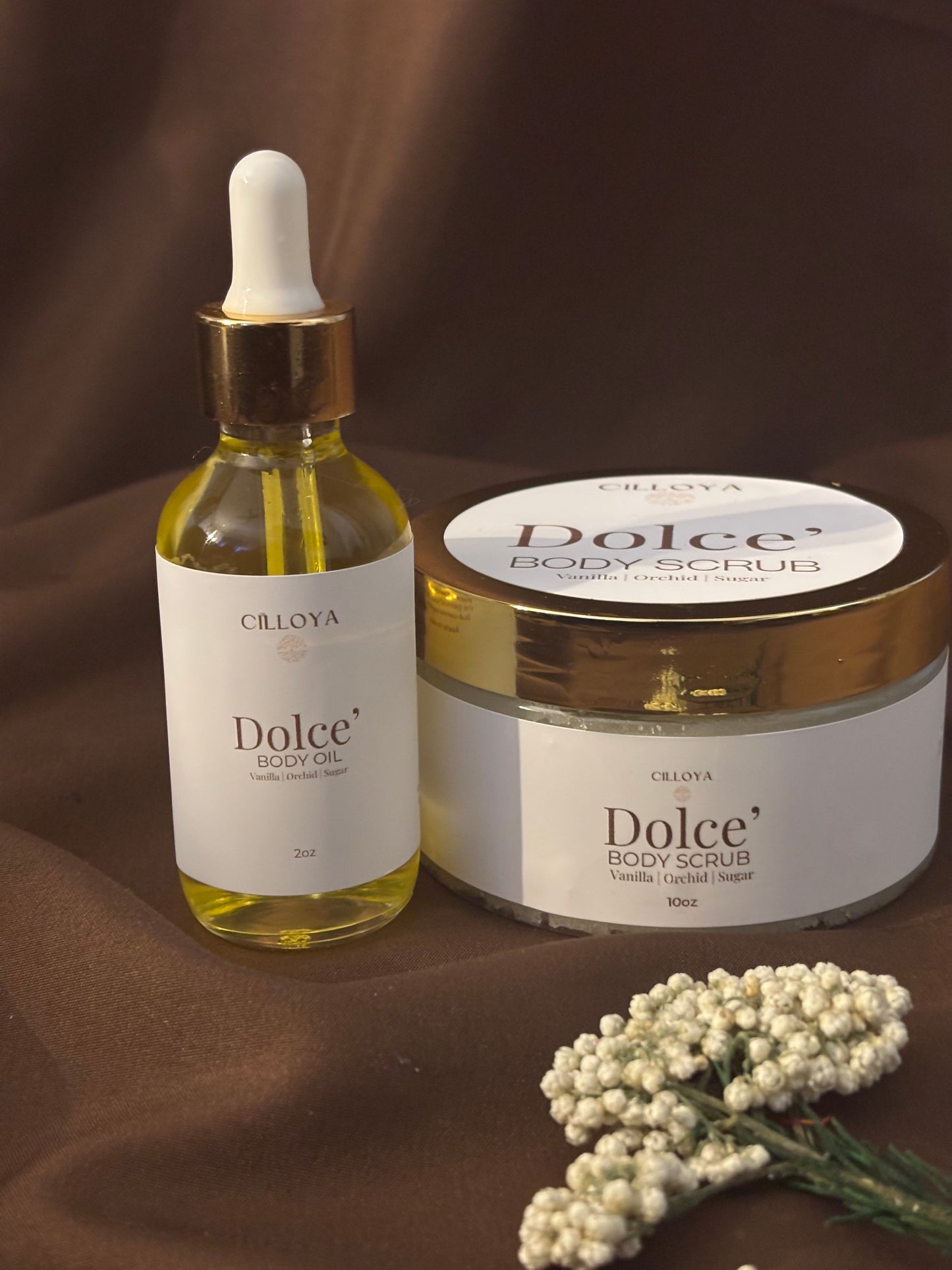 Cilloya Radiance Experience gift set featuring a 2oz Dolce' Body Oil and a 10oz Dolce' Body Scrub on a dark brown backdrop